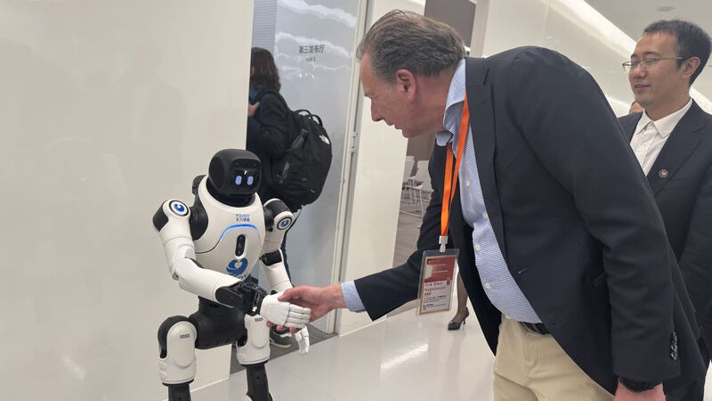 Erik Klein Nagelvoort schudt hand van robot